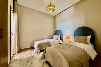 a bedroom with two beds and a window at Modern 2-Bedroom Apartment in Agdal with Pool & Terrace in Marrakech
