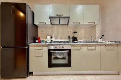a kitchen with a stove and a refrigerator at Modern 2-Bedroom Apartment in Agdal with Pool & Terrace in Marrakech