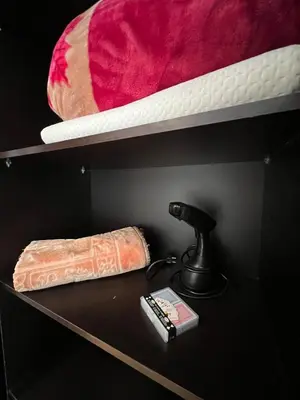 a black shelf with a lamp and a mattress at Appartement neuf & moderne avec clim, piscine & balcon,Proche Jemaa el-Fna & Guéliz in Marrakech