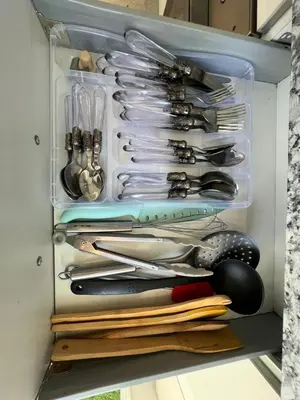 a drawer full of utensils in a refrigerator at Appartement neuf & moderne avec clim, piscine & balcon,Proche Jemaa el-Fna & Guéliz in Marrakech