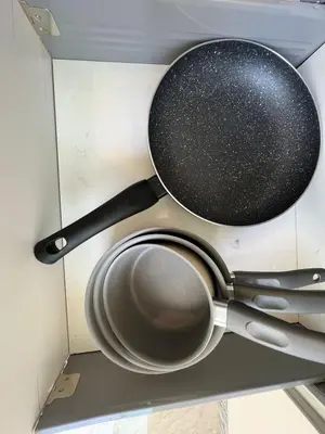 two pots and pans hanging on a wall at Appartement neuf & moderne avec clim, piscine & balcon,Proche Jemaa el-Fna & Guéliz in Marrakech