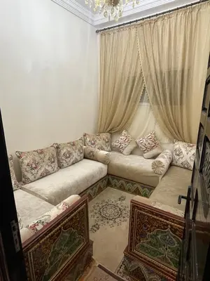 a living room with a couch and a window at Appartement neuf bien situé in Marrakech