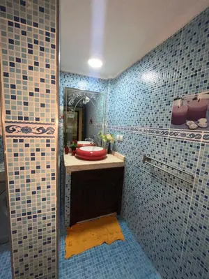 a bathroom with a sink and a mirror at Appartement neuf bien situé in Marrakech