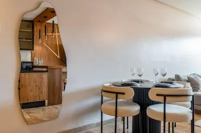 a dining room with a table and four chairs at 1 Ch, 1 SDB et Parking gratuit au Centre de Gueliz avec vue in Marrakech