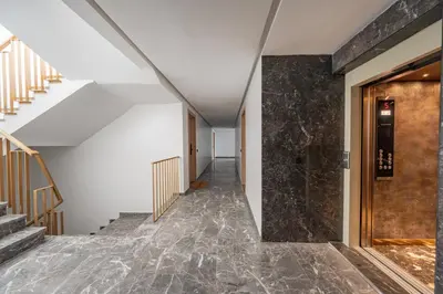 a hallway with stairs and a stone wall at 1 Ch, 1 SDB et Parking gratuit au Centre de Gueliz avec vue in Marrakech