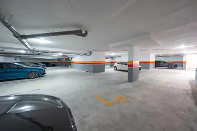 a parking garage with two cars parked in it at 1 Ch, 1 SDB et Parking gratuit au Centre de Gueliz avec vue in Marrakech
