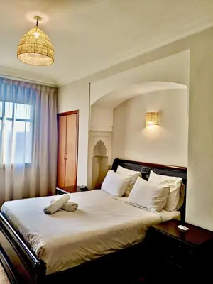 a bedroom with a bed with a stuffed animal on it at charming mini villa in Marrakech