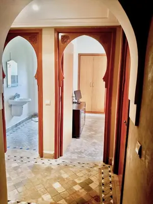 an archway leading to a bathroom in a house at charming mini villa in Marrakech