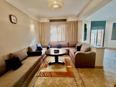 a living room with a couch and a table at charming mini villa in Marrakech
