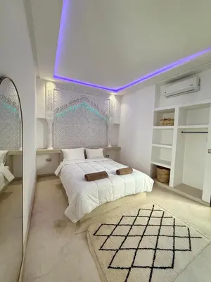 a bedroom with a bed with a purple ceiling at Riad La Rose in Marrakech