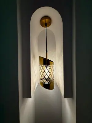 a light hanging from a wall in a room at Riad La Rose in Marrakech