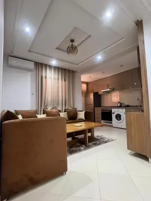 a living room with a couch and a table at Appartement cosy à 8 min de RAK à pied in Marrakech