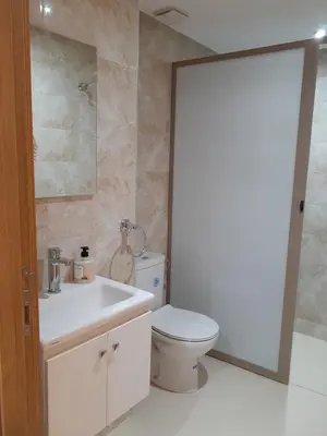 a bathroom with a white toilet and a sink at Appartement cosy à 8 min de RAK à pied in Marrakech