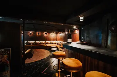a bar with stools and a table in a room at La Villa Wassim in Marrakech