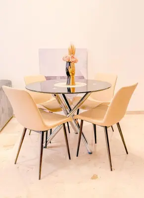 a dining room table with chairs and a vase on it at Modern apartment in Gueliz Luxury residence in Marrakech