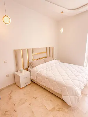 a bedroom with a large bed and a night stand at Modern apartment in Gueliz Luxury residence in Marrakech