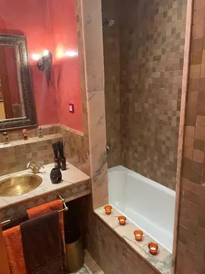 a bathroom with a sink and a bath tub and a sink at Appartement les jardins de la Palmeraie III in Marrakech