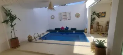 a living room with a swimming pool in a house at VILLA Malaika in Marrakech