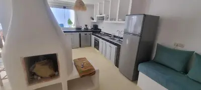 a kitchen with a fireplace in the middle of a living room at VILLA Malaika in Marrakech