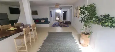 a living room with a table and chairs and a plant at VILLA Malaika in Marrakech