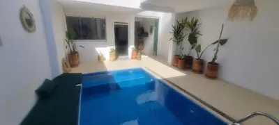 a blue swimming pool in a room with potted plants at VILLA Malaika in Marrakech