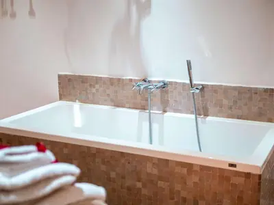 a bathroom with a bath tub with towels in it at Riad la Source du Desert in Marrakech