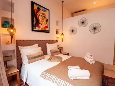 a bedroom with a bed with towels on it at Riad la Source du Desert in Marrakech