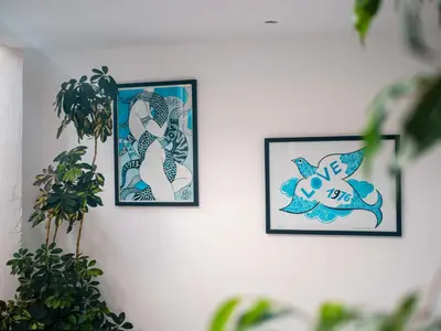 two framed pictures of mermaids on a wall at Riad la Source du Desert in Marrakech