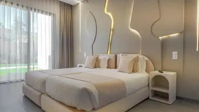 a white bed in a room with a large window at Villa SLIMANE - Villa plain-pied sans vis à vis in Marrakech
