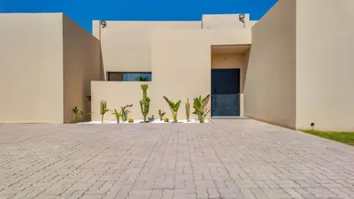 a house with a brick driveway in front of a building at Villa SLIMANE - Villa plain-pied sans vis à vis in Marrakech