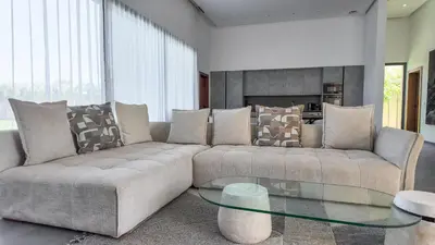 a living room with a couch and a glass table at Villa SLIMANE - Villa plain-pied sans vis à vis in Marrakech