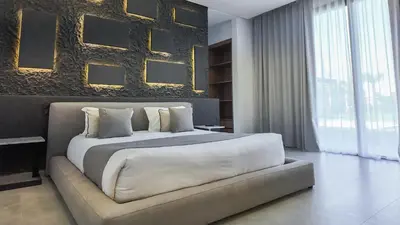 a bedroom with a large bed and a wall with pictures at Villa SLIMANE - Villa plain-pied sans vis à vis in Marrakech
