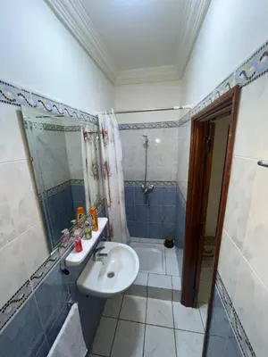 a bathroom with a sink and a shower and a tub at Riad Mounaf in Marrakech