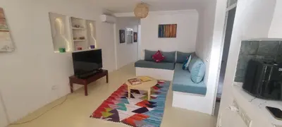 a living room with a couch and a table at Villa NAIM in Marrakech