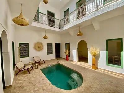 a large room with a swimming pool in a building at Riad Nouonsa 4ch 8 pax Medina Bab Taghzout in Marrakech