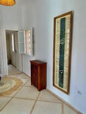 a room with a window and a wooden cabinet on a wall at Riad Nouonsa 4ch 8 pax Medina Bab Taghzout in Marrakech