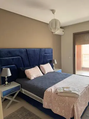 a blue bed with a blue headboard in a bedroom at Near Gueliz 2 Bedrooms 3 ACs Fast WiFi Netflix in Marrakech