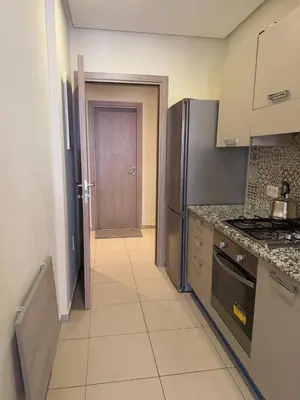 a kitchen with a stove and a door to a hallway at Near Gueliz 2 Bedrooms 3 ACs Fast WiFi Netflix in Marrakech