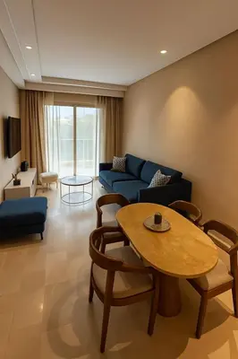 a living room with a blue couch and a table at Appartement prestigia Marrakech in Marrakech