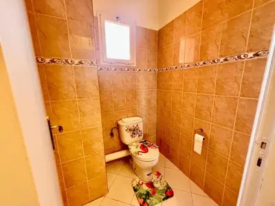 a bathroom with a toilet and a window at NF15 by Majestic Properties in Marrakech
