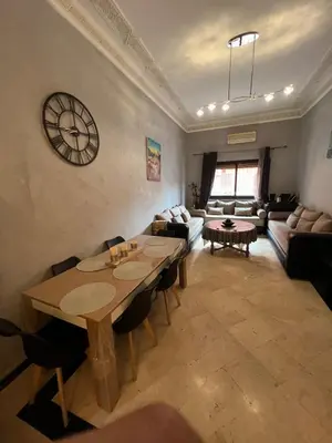 a living room with a table and a couch at Apartment NE 4 by Majestic Properties in Marrakech