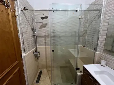 a glass shower in a bathroom with a sink at Apartment NE 4 by Majestic Properties in Marrakech