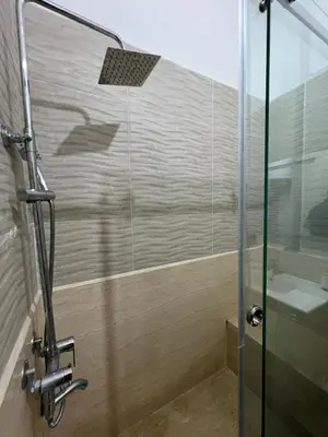 a shower with a glass door and a sink at Apartment NE 4 by Majestic Properties in Marrakech