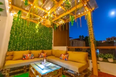 a couch sitting under a pergola on a patio at Au cœur du centre ville Gueliz a coté de Carre Eden et Plaza in Marrakech