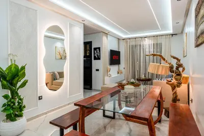a living room with a glass table and a couch at The Marrakech Mosaic A Fusion of Style city Central in Marrakech