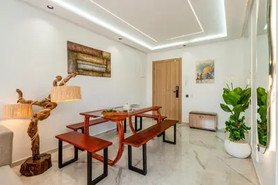 a living room with a wooden table and benches at The Marrakech Mosaic A Fusion of Style city Central in Marrakech