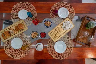 a table with plates and food on top of it at The Marrakech Mosaic A Fusion of Style city Central in Marrakech
