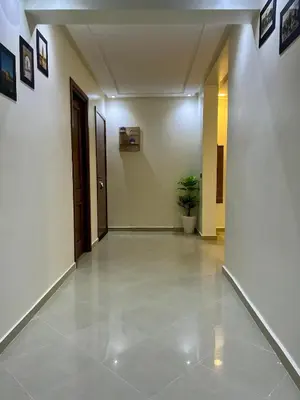 an empty hallway with a potted plant in a building at Appartement familière luxe hay menara in Marrakech