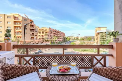 a table with a bowl of food on a balcony at Wintering I Authentic Accommodation I Pool in Marrakech