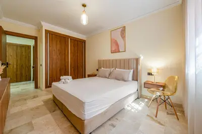 a bedroom with a bed and a desk and a chair at Atlas Dream Studio pool & parking included in Marrakech